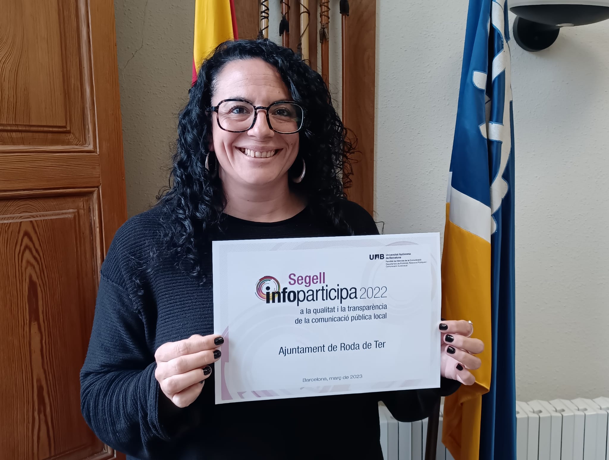 La regidora de Comunicació, Roser Montané, mostra el segell Infoparticipa 2022, el qual és un reconeixement a la qualitat i a la transparència informativa del web municipal.